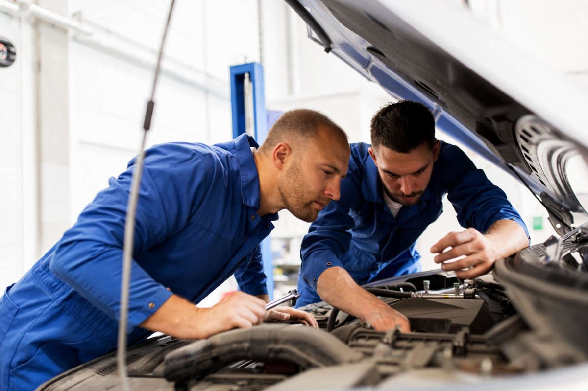 two technicians working on a vehicle