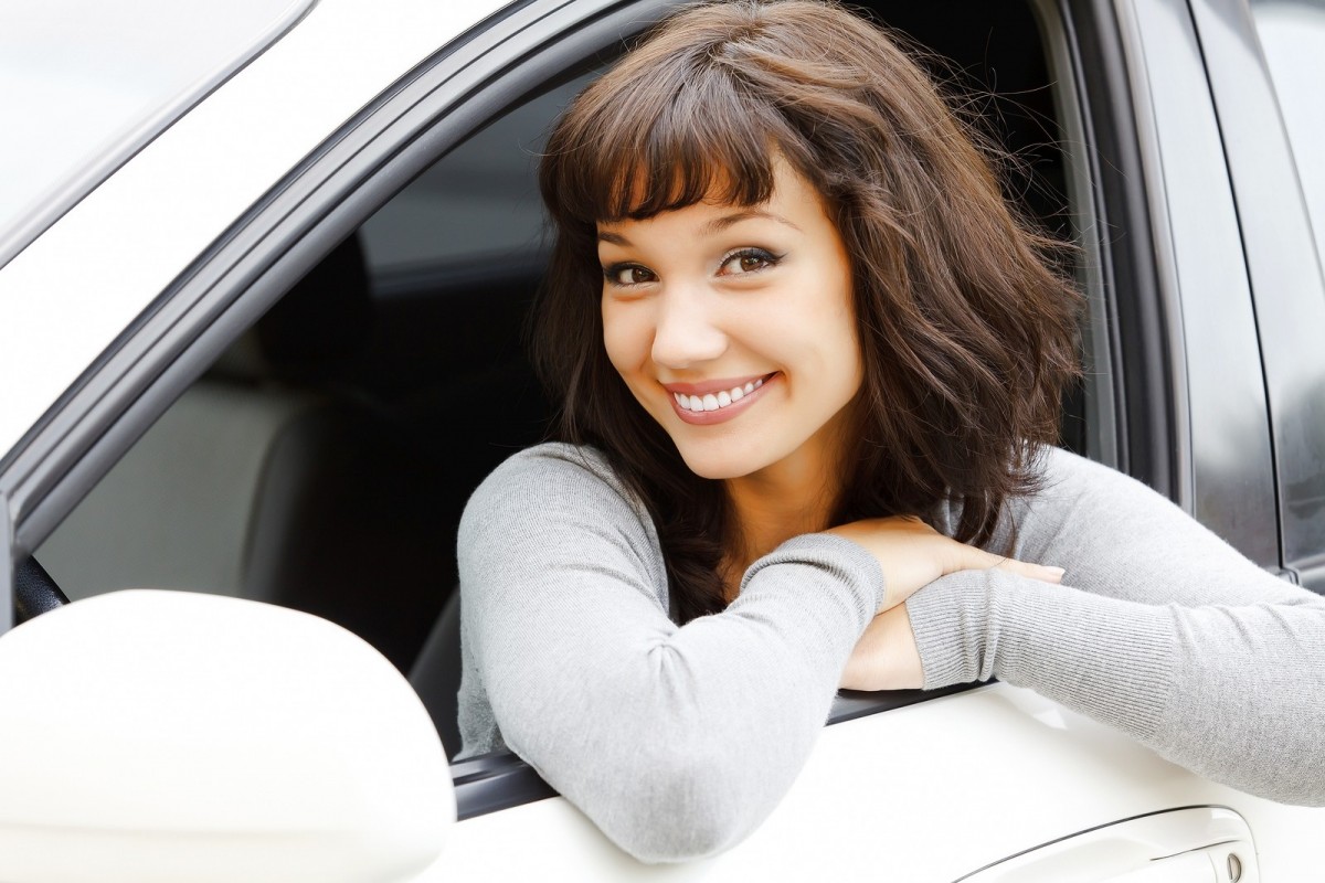 woman smiling on edge of car window