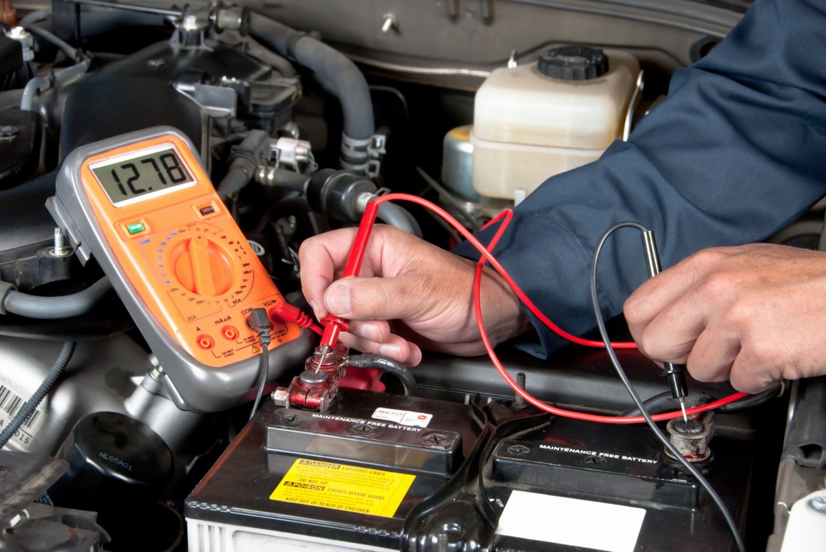 battery diagnostics being ran on a car battery by a mechanic